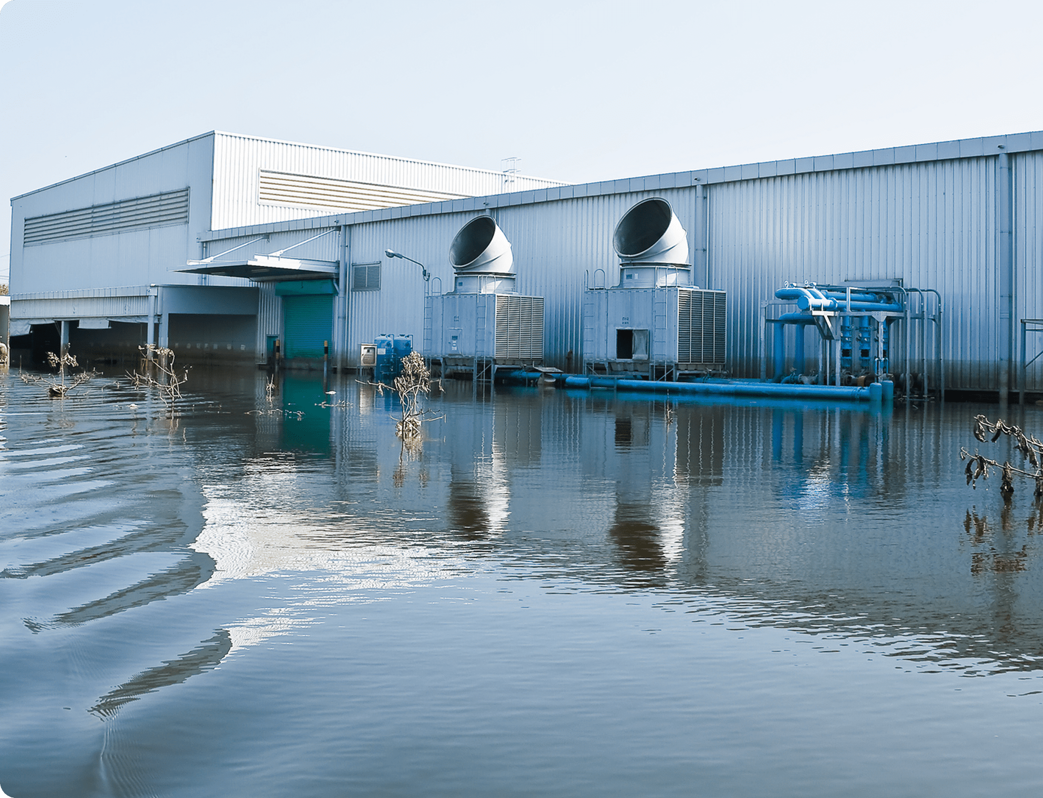 Water surrounds a factory structure